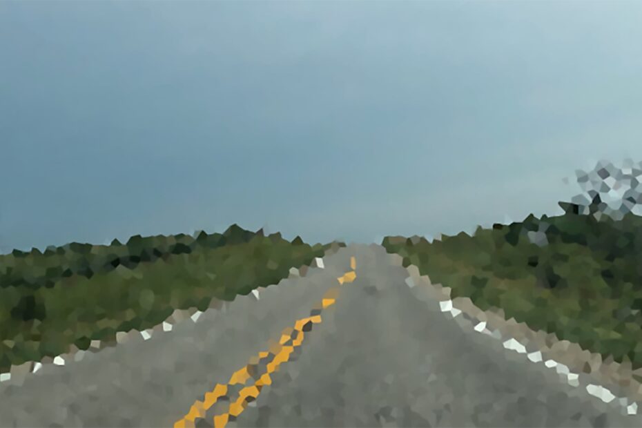 A pixelated view of an empty two-lane road.